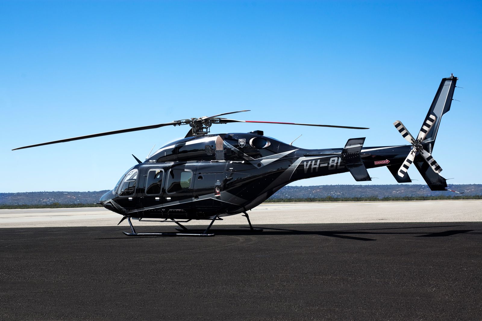 Bell 429 Helicopter used for mining and government charter flights sitting on the tarmac at an Australian airport.