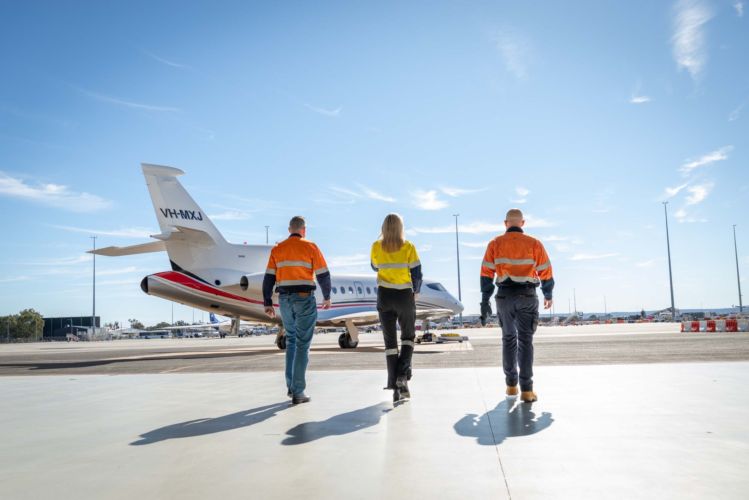 Miners walking out to a private jet