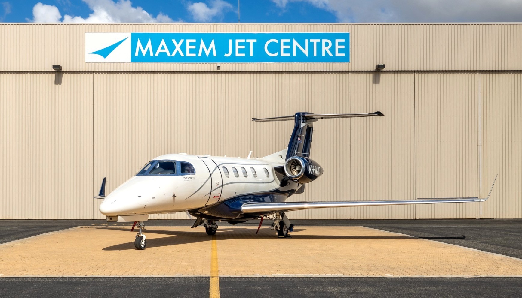 Embraer EMB-505 Phenom 300 jet outside the Maxem Aviation hanger at Perth Airport.